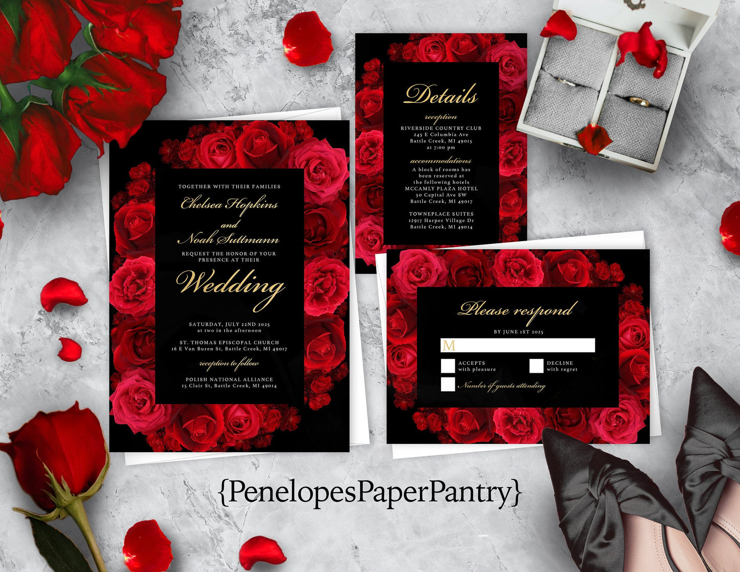 A set of wedding invitations with black background and red floral patterns, including details cards and an envelope, displayed on a surface with red roses scattered around.